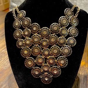 V shape two strand necklace with linked round design, and rhinestone centers.